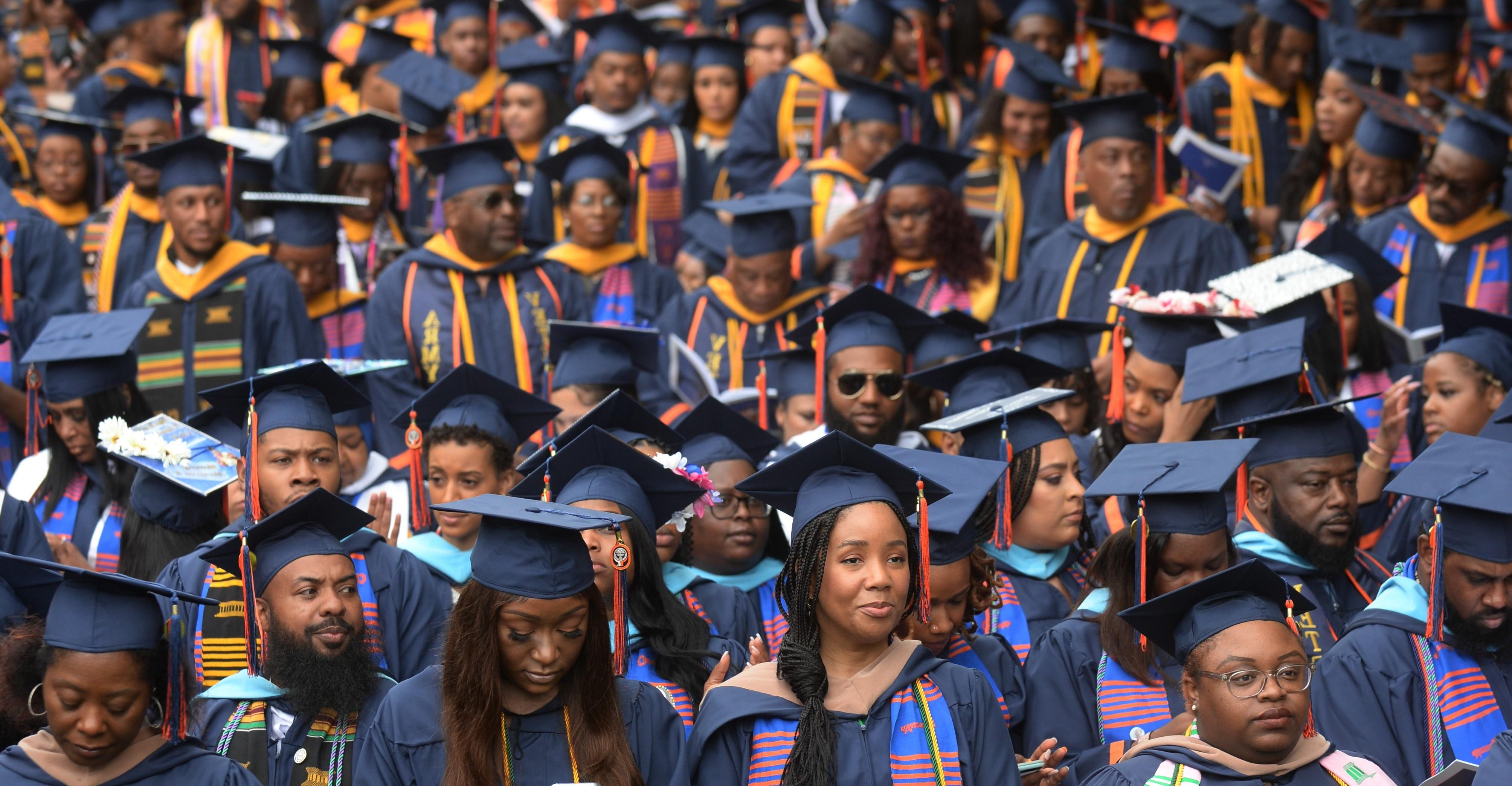 three students graduating